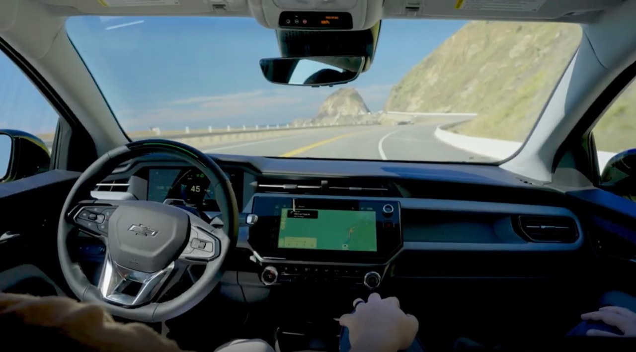 Driver using Super Cruise on a scenic road.