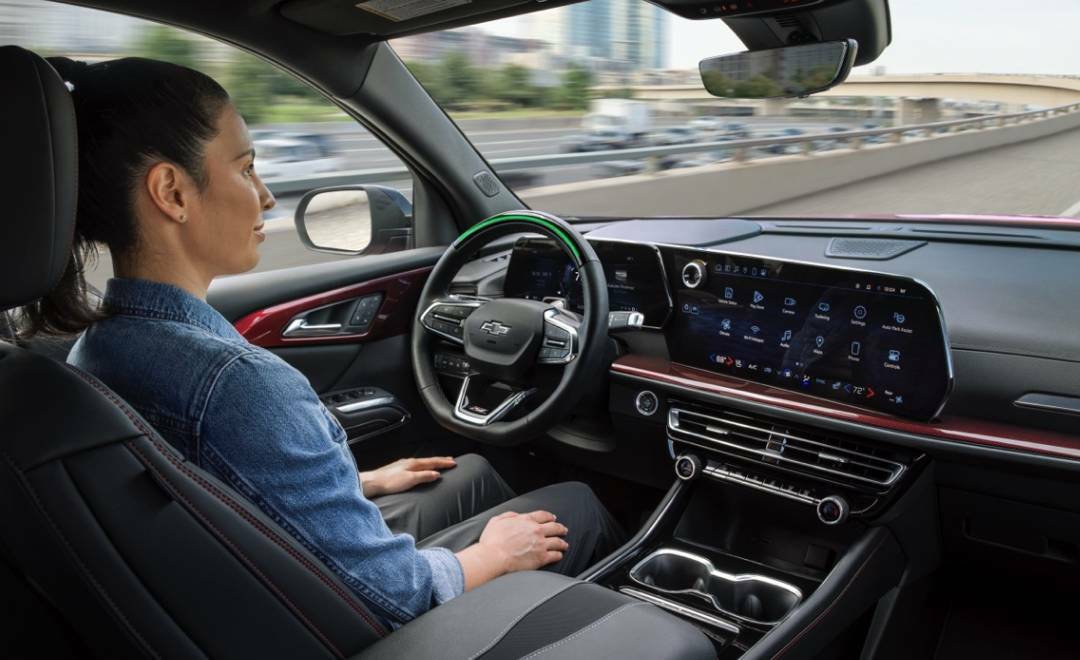Back Seat View of a Woman Driving a GM Vehicle Using Hands-free Technology