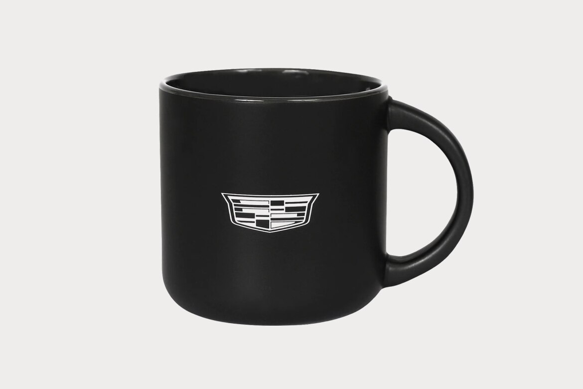 Black Ceramic Mug with Sleek Design and White Cadillac Logo on Front.