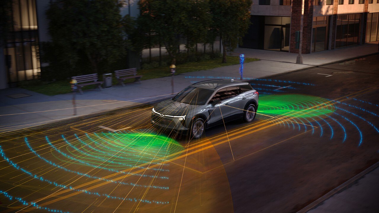 Chevrolet EV SUV demonstrating autonomous driving technology with visualized LiDAR and sensor fields on urban street.