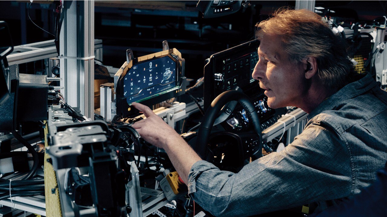 Close-up of a GM Employee Working on the Technology of a GM Vehicle's Dashboard Settings